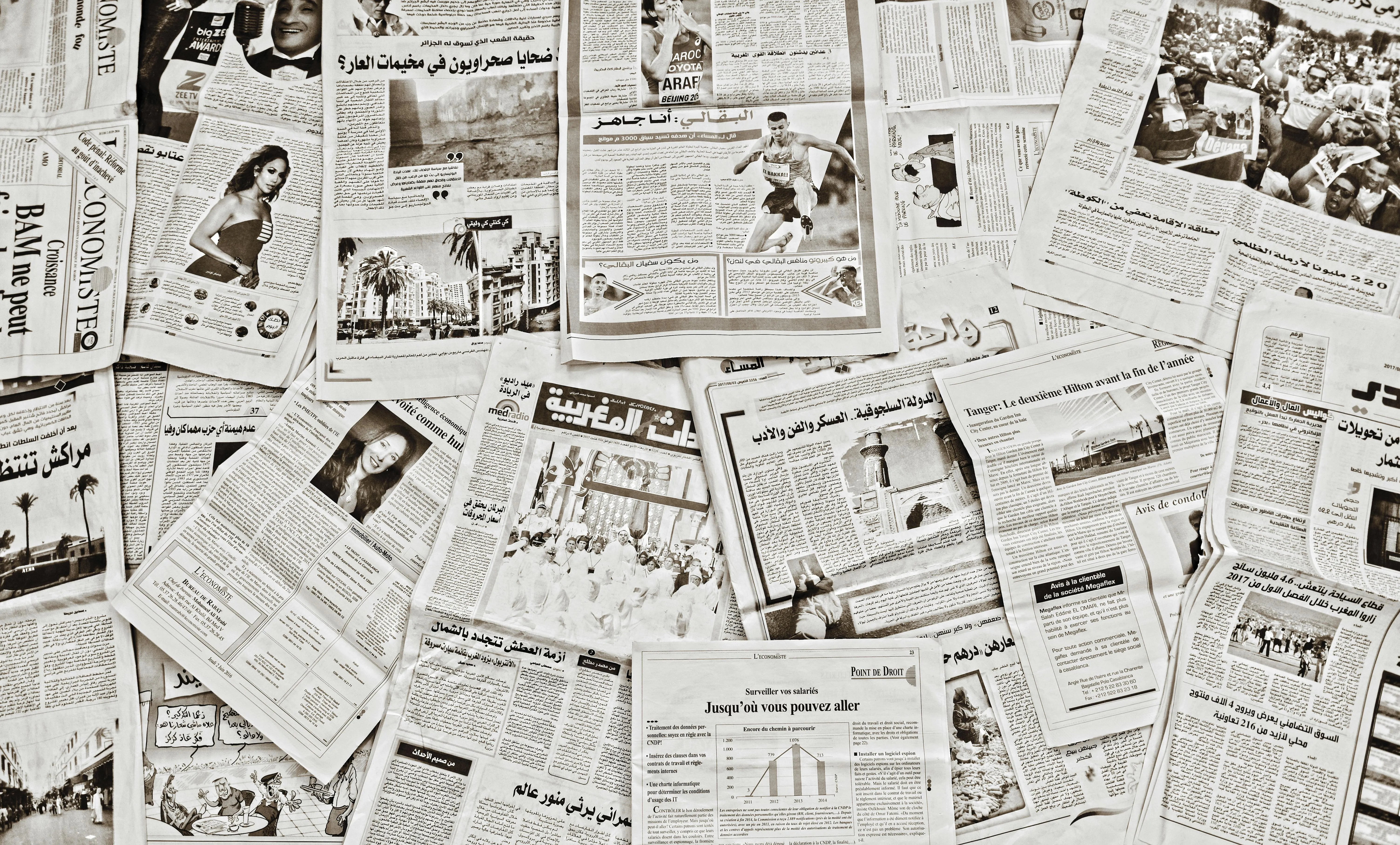 Sprawling newspapers representing the information landscape